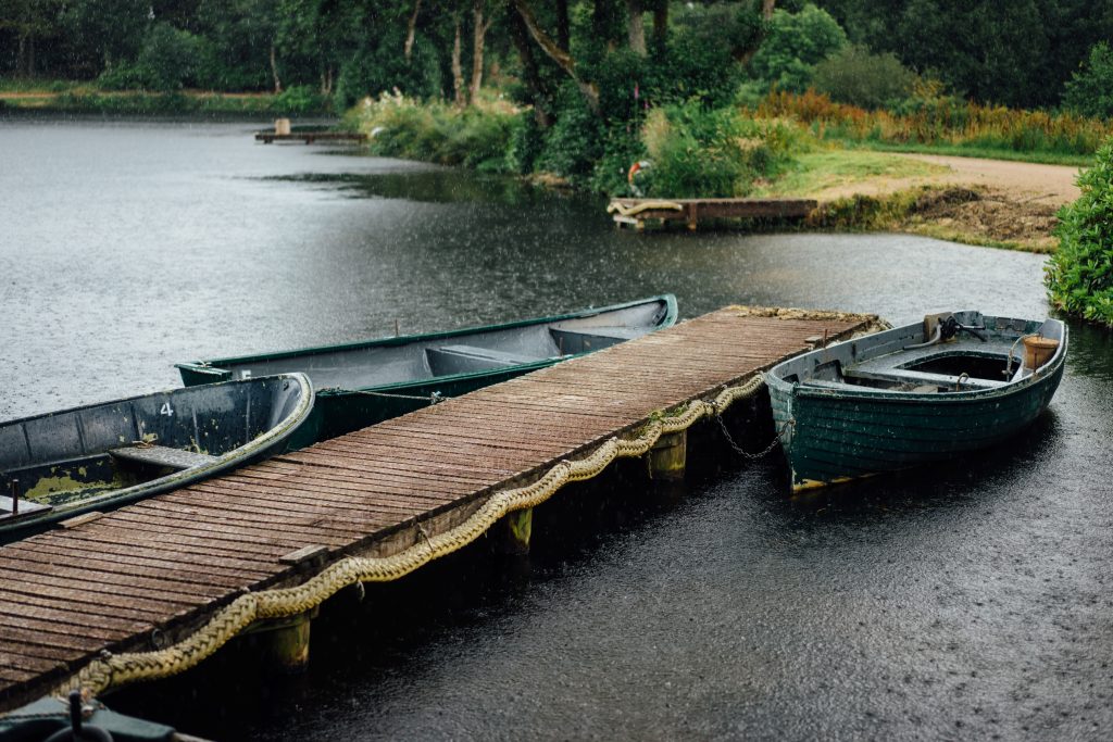 Rain is part of the adventure travel industry, don't let it stop your business like it did to these three boats next to a dock. Photo by Paul Rysz